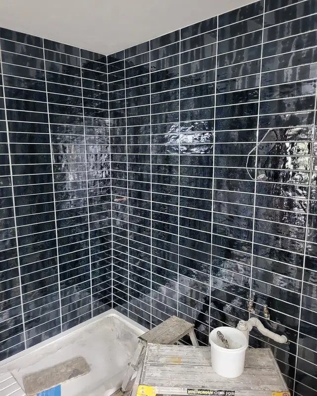Navy glazed metro tiles in a shower enclosure